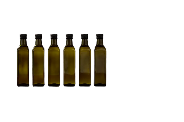 Six green glass bottles of varying sizes on a white background